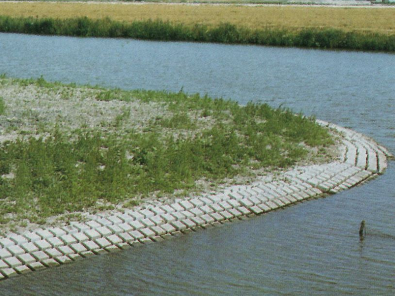 Flexmat concrete blocks along the embankment of a river bed.